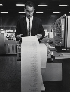 Man looking over printout in IBM Factory, Sindelfingen, West Germany