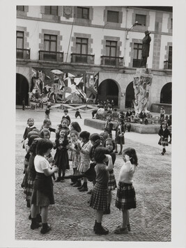 Girls playing ring-around-the-rosie on the Guernica City Hall square in front of a reproduction of...