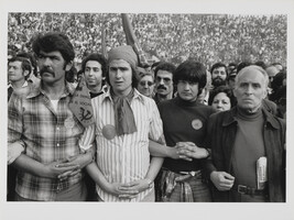 Men stand and link arms during a Communist Party meeting held in a bullring, Conference of Socialist...