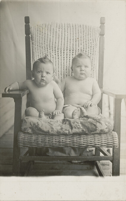Twins Wearing Diapers, Seated in a Chair