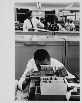 Man using machine in IBM factory, Mainz, West Germany