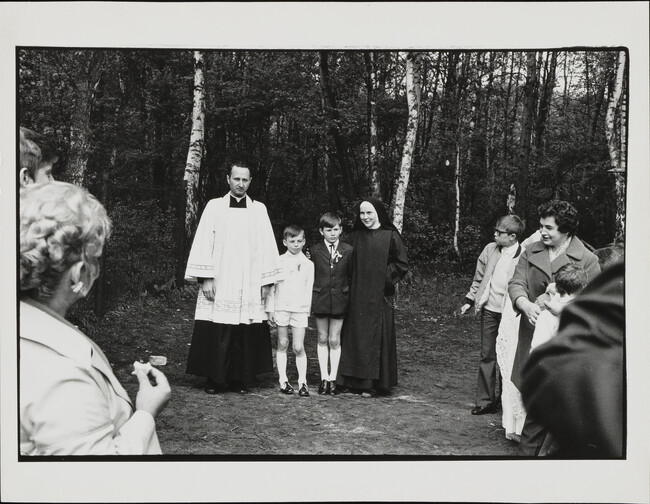 Priest and nun stand with boys, village outside Warsaw, Poland