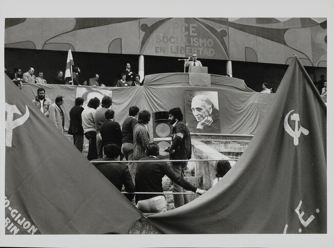 Communist party meeting in bullring. Posters of Dolores Ibárruri, “La Pasionaria” (she was expected to come but did not attend). Santiago Carrillo, general secretary of Spanish Communist party, speaking, Oviedo, Spain, May 15, 1977