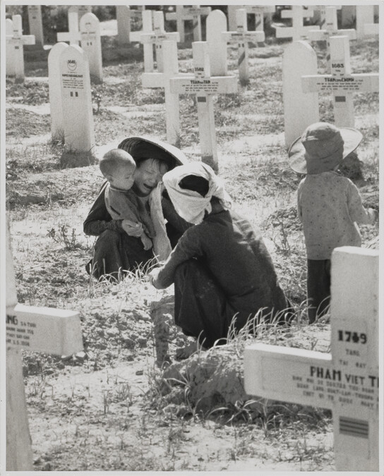Women and children at graveside. Nam Dinh, Vietname, May 21, 1954