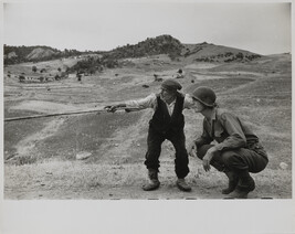 Sicilian peasant telling an American officer which way the Germans had gone.  Near Troina, Italy,...