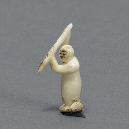 Miniature Carving of a Man Holding a Harpoon