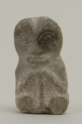 Carving of a Seated Man