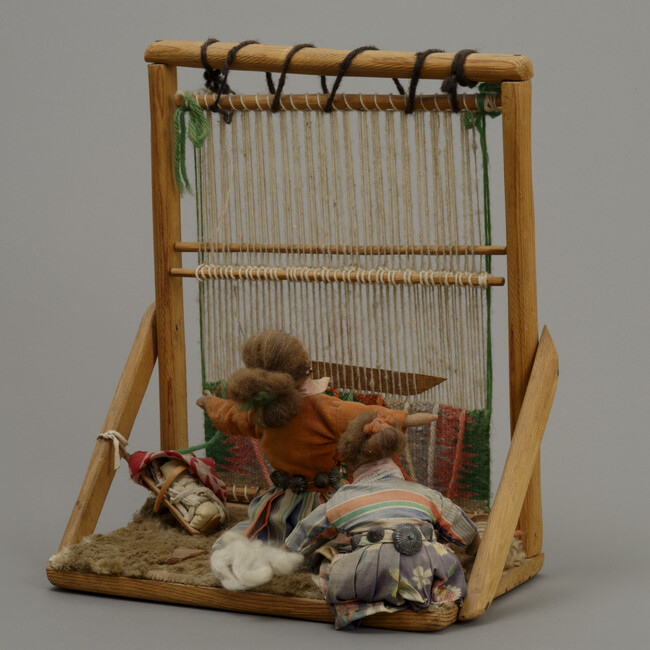 Two Diné Women, a Loom, and a Cradleboard with a Child