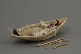 Model of a Sioux Man and Child in Bull Boat