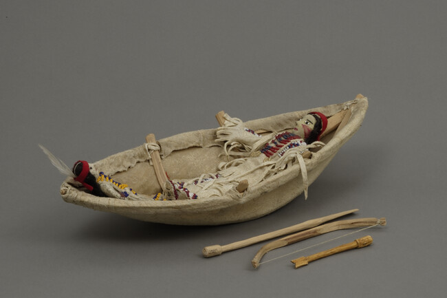 Model of a Sioux Man and Child in Bull Boat