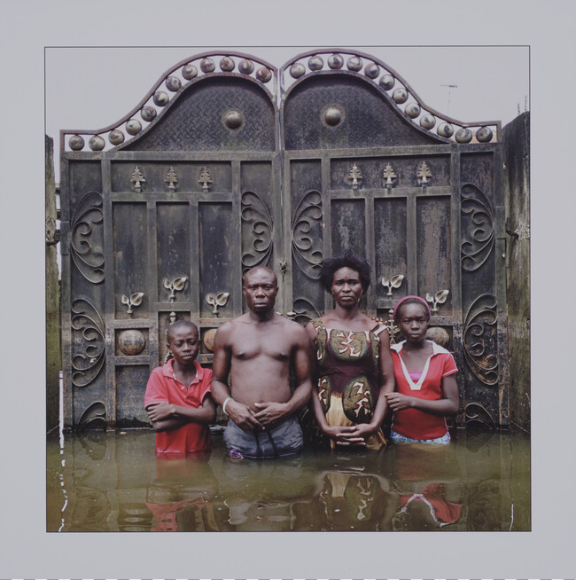 Joseph Edem, and his wife Endurance and children Godfreedom, aged 10, and Josephine, 12, stand in front of thier Igobeni House, Nigeria; from the portolio Drowning World