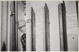 Untitled (George Maciunas behind door, face hidden by mask)