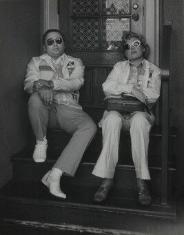 Couple sitting in Stairwell Wearing Sunglasses