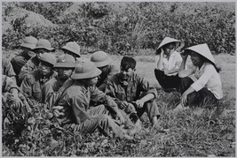 Soldiers and young women on a break from clearing the minefield, Kurangchi Province, Vietnam