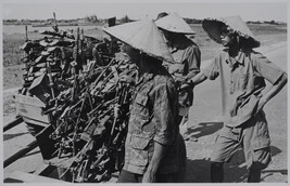 Viet Cong soldiers collecting weapons