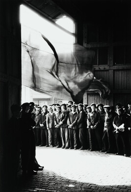 Chinese workers gather under windswept banner