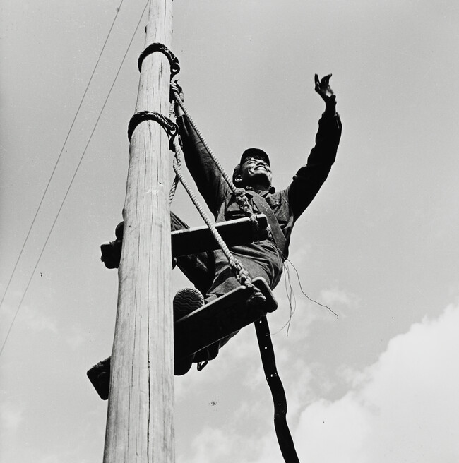 Man high on pole, China