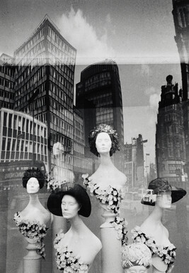 Storefront reflection with wigs, High Street, London, UK