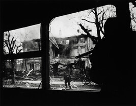 Soldier firing from inside a trolley car, Germany