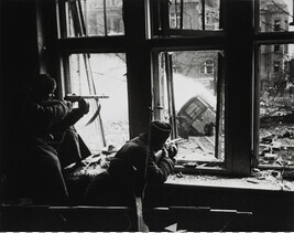 Soldiers firing out of a window