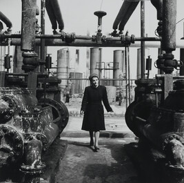 Fashionable Woman Walking in a Factory