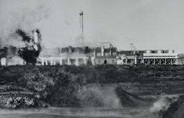 The Scorched Earth: Heat-Distorted View of Factory Exterior