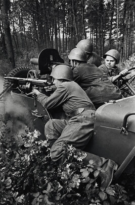 Soldiers firing from the back of a jeep
