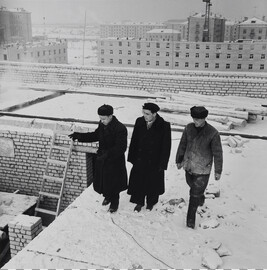 Three Men on a Snowy Rooftop