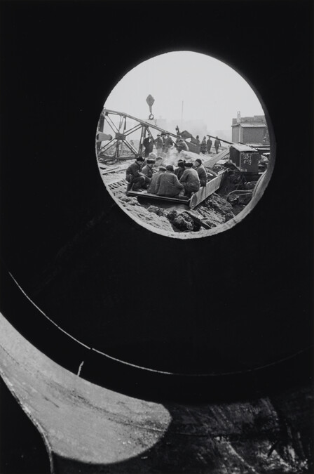 Seated Workers Viewed Through Porthole