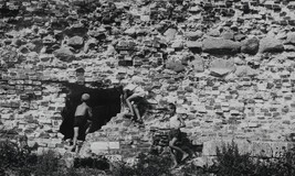 Three Boys at Play on a Ruined Well