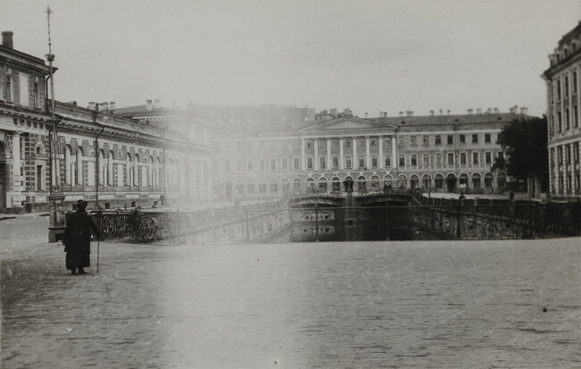 Scene of woman in plaza with canal below, Leningrad