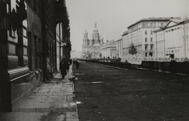 View of street and man with cane with onion dome palace in background, Leningrad