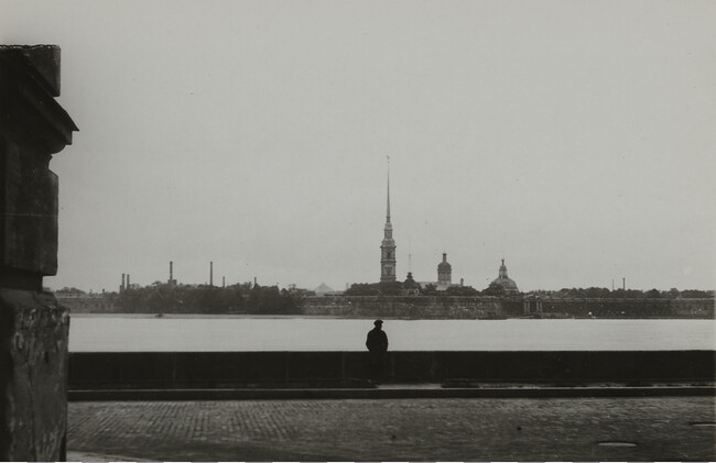 View of river with man in foreground and spire in background, Leningrad