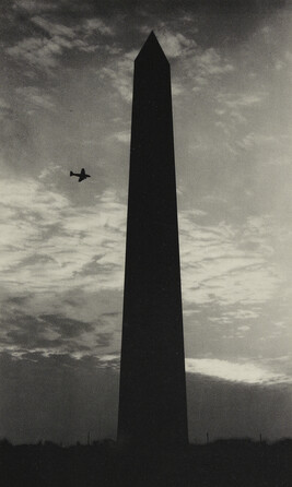 Washington Monument with passing airplane