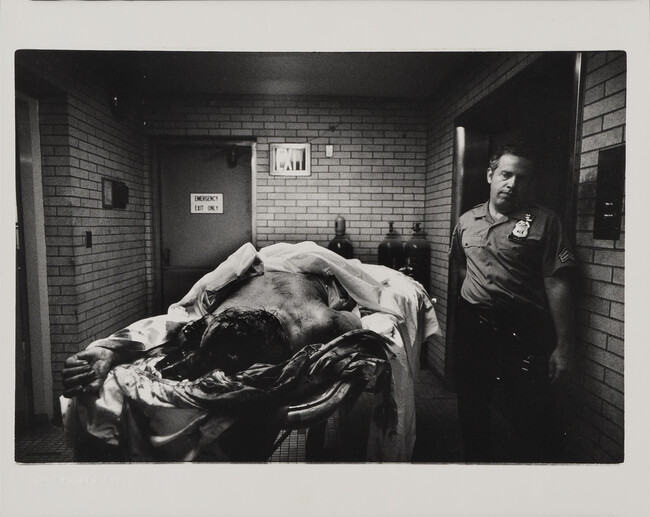 Alternate image #1 of Woman who jumped to her death with hypodermic syringe in her hand is searched by a policeman in morgue; all police must take their turn at this kind of work; 9th Police Precinct, Homicide Task Force under Detective Sgt. Gerald Mc Queen(the real Kojak), New York City