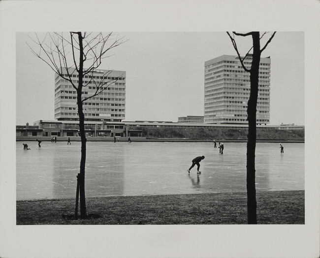 Alternate image #2 of Skaters and Walkers on Frozen Canal with Modern Buildings in Background, Amsterdam, Holland