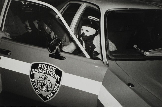 Alternate image #3 of Halloween. A Young Man Dressed as an Angel seeks a Ride in a Patrol Car