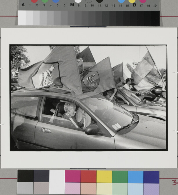 Alternate image #1 of Old woman in car holding flag, Rome, Italy