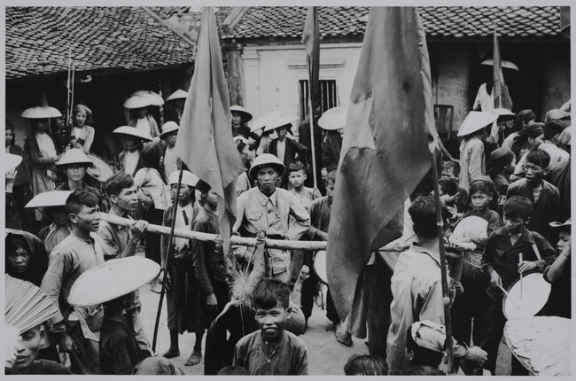 Alternate image #1 of Crowd with suckling pig on a stick, Vietnam