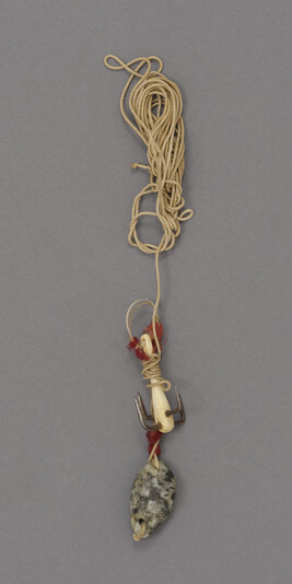 Hard twist cotton attached to a stone sinker and a four pronged hook with an ivory shank with red wool...