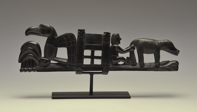 Alternate image #1 of Argillite Ship Panel Pipe with a Spray of Foliage surmounted by a Dog or Wolf; a seated  Anglo-European Figure holding the Dog's Tail; a Stylized Cabin; a Eagle Holding a Sprig of Tobacco Leaves and Berries in it's Claws