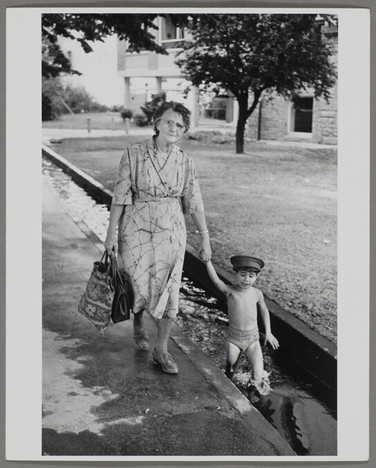 Alternate image #2 of Woman Walking with Boy in Small Canal, Freiburg, West Germany