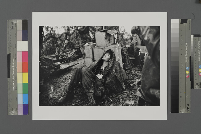 Alternate image #2 of A U. S. Paratroooper Wounded in the Battle for Hamburger Hill Grimaces in Pain as he Awaits Medical Evacuation at Base Camp Near the Laotian Border, May 19, 1969