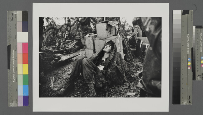 Alternate image #1 of A U. S. Paratroooper Wounded in the Battle for Hamburger Hill Grimaces in Pain as he Awaits Medical Evacuation at Base Camp Near the Laotian Border, May 19, 1969
