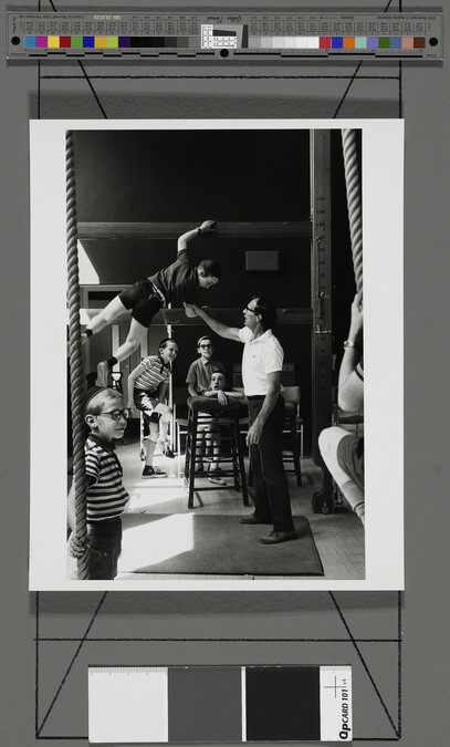 Alternate image #2 of Boy climbing in gymnasium, London, England