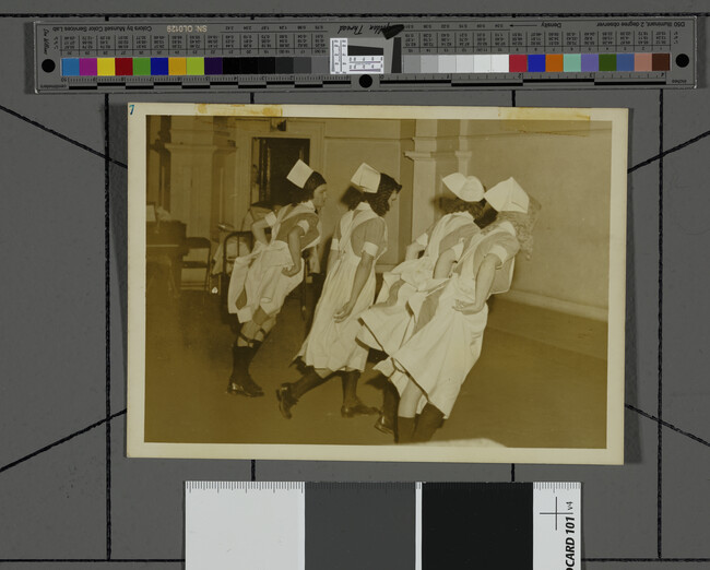 Alternate image #1 of Men Dressed as Nurses Dancing in a Row with Backs to Camera