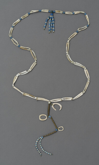 Necklace with pendant of coiled brass, shells, and beads