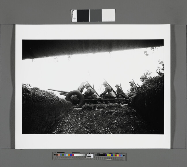 Alternate image #1 of Soldiers advancing with a heavy gun, seen from a trench