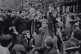 Writer Louis Aragon addressing the crowd through a bullhorn at the Place de la Sorbonne; student leader...