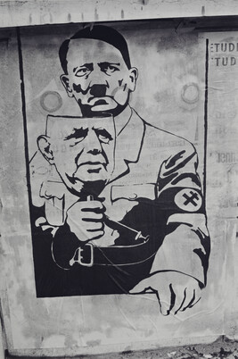 Poster showing Hitler with a de Gaulle mask; the Cross of Lorraine replaces the swastika on his armband,...